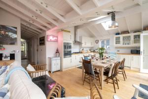 a kitchen and dining room with a table and chairs at 3 Uplands, Thorpeness - Sleeps 3, Close to Beach, Boating Lake, Thorpeness Golf Club and Country Club - Aldeburgh Coastal Cottages in Thorpeness