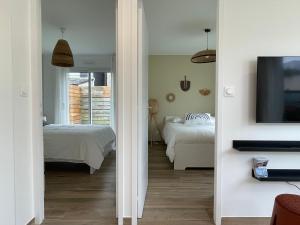 En eller flere senge i et værelse på Petite maison cosy