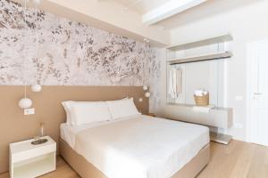 Postel nebo postele na pokoji v ubytování Dimora Bramante Rooms