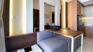 a kitchen with a table and a chair in a room at Nice and Homey 2BR at Citra Living Apartment By Travelio in Jakarta