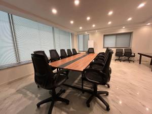 a large conference room with a long table and chairs at Hotel One The Mall, Lahore in Lahore