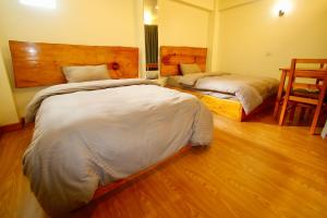 Katil atau katil-katil dalam bilik di Lumwoh Guest House