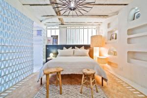 a bedroom with a large bed and a table at Lab Loft à Bastille 110m2 in Paris +9 photos