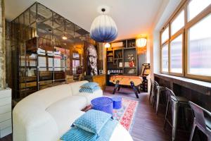 a living room with a white couch and a table at Lab Loft à Bastille 110m2 in Paris