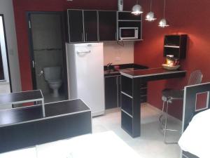 a small kitchen with a refrigerator and a sink at Carlos 1° in Salta