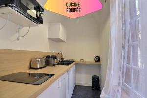 a kitchen with a sink and a counter top at Le logis de Madeleine - ideal couple / solo - coeur de la ville - proche gare in Troyes