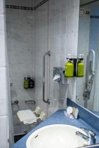 a bathroom with a sink and a shower at Holiday Inn Express Royal Docks by IHG in London