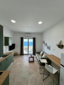 a kitchen and living room with a couch and a table at The Dice in Pachaina