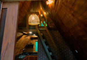 an attic with a light hanging from the ceiling at Syara villa in Unawatuna