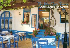 a restaurant with blue and white tables and chairs at Lydia in Samos +44 photos
