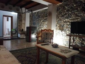 a living room with a couch and a table and a tv at Lydia in Samos