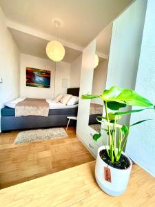 a bedroom with a bed and a potted plant at Gästeapartment Leipzig City in Leipzig