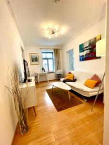 a living room with a couch and a table at Gästeapartment Leipzig City in Leipzig +4 photos