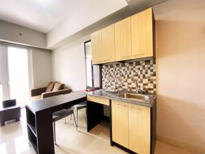 a kitchen with a sink and a counter top at Fancy 2BR at Skyland City Jatinangor Apartment By Travelio in Sumedang +14 photos