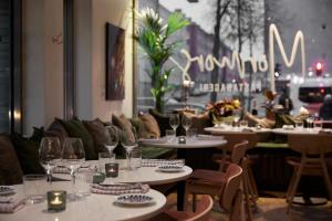 a restaurant with tables and chairs with wine glasses at Sky Hotel Apartments, Stockholm in Stockholm