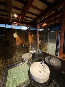 a bathroom with a sink and a toilet and a mirror at Marmaram Heritage in Vagamon +32 photos