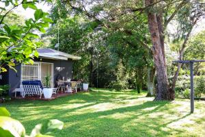 a house with a yard with a patio at Vaal River Garden Cottage in Theoville