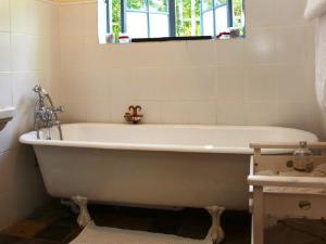 a white bath tub in a bathroom with a window at Lavender’s Blue in Stanford +9 photos