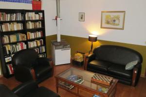 a living room with two chairs and a couch and a table at Maison 90m2 avec grand parc au bord de la rivière in Montredon-Labessonnié