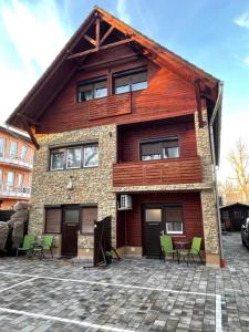 a house with chairs in front of it at New Beachapartman in Siófok