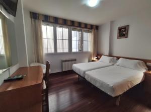 Łóżko lub łóżka w pokoju w obiekcie Hotel Hórreo by Bossh! Hotels