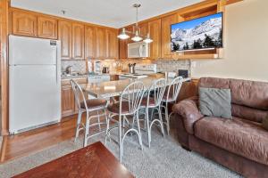 a kitchen with a couch and a table with chairs at ML324 1BR 1BA Mountain View Connects To ML326 WiFi in Snowshoe