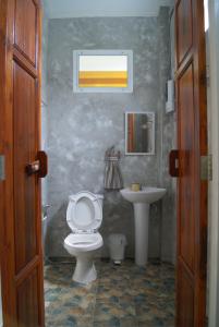 a bathroom with a toilet and a sink at Sichang My home in Ko Si Chang