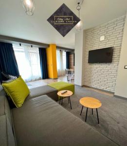 a living room with a couch and two tables at City Art Luxury Living Free Parking in Ruse