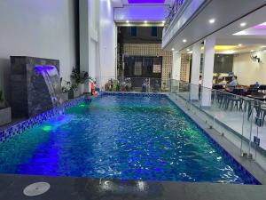 a large swimming pool with a water feature in a building at Center Tam Coc Homestay in Ninh Binh