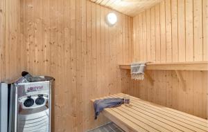a inside of a sauna with a washing machine at 7 Bedroom Nice Home In Hvide Sande in Nørre Lyngvig