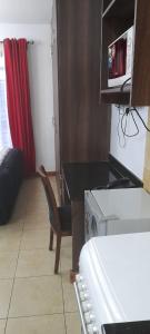 a small kitchen with a table and a microwave at LN EXECUTIVE FURNISHED WEST STUDIOs in Nairobi