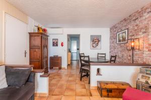 a living room with a couch and a table at La Favière proche de la plage in Bormes-les-Mimosas