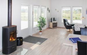 a living room with a wood stove in it at Holiday Home Sivsangervej Vestervig X in Vestervig