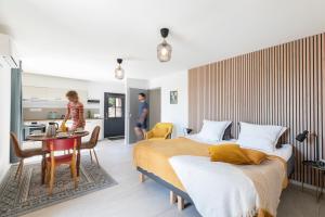 Una habitación de hotel con dos camas y cocina. en La Tour du Blé - gîtes et chambres d'hôtes, en Salornay-sur-Guye 85 fotos más