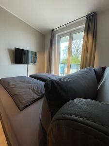 a living room with a couch and a window at Exklusives Wohnen im historischen Wasserturm dem Highlight von Delitzsch WE104 in Delitzsch