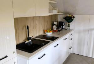 a kitchen with a sink and a bowl of fruit at Restauracja Dajana in Bełchatów