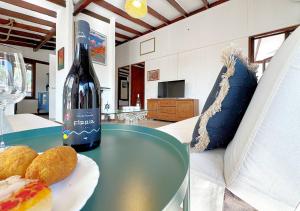 butelkę wina i talerz pączków na stole w obiekcie Solemar Sicilia - Seaside House Capo Zafferano w mieście Santa Flavia