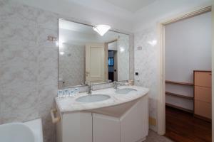 a bathroom with two sinks and a large mirror at Cooker Chianti in Florence +71 photos