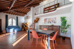 a dining room with a table and orange chairs at Cooker Chianti in Florence