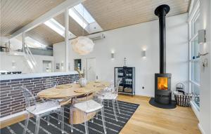 a dining room with a table and a fireplace at Beautiful Home In Hjørring With Wifi in Hjørring