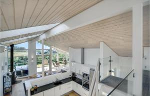 a kitchen with white cabinets and a wooden ceiling at Beautiful Home In Hjørring With Wifi in Hjørring