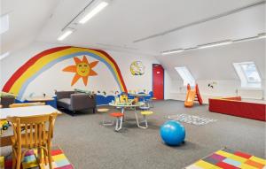 a room with a rainbow and a table and chairs at Apartment No 195 in Sønderby +29 photos
