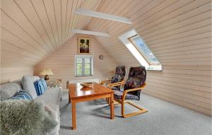 a living room with a table and chairs in a attic at 1 Bedroom Beautiful Home In Roslev in Roslev +13 photos