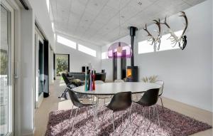 ein Esszimmer mit einem weißen Tisch und Stühlen in der Unterkunft Holiday Home Hemmet With Fireplace 03 in Hemmet
