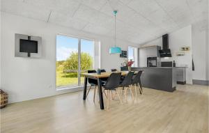 a dining room and kitchen with a table and chairs at 3 Bedroom Beautiful Home In Jerup in Jerup
