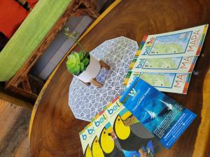 a wooden table with books and a plant on it at D's Inn in San Ignacio