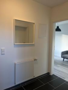 a room with a mirror and a radiator on the wall at Appartement No1 in Witten