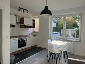 a kitchen with a table and chairs and a window at Appartement No1 in Witten