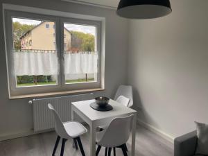 a living room with a table and chairs and a window at Appartement No1 in Witten +9 photos