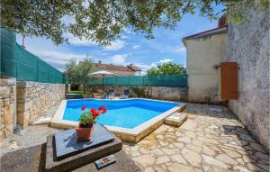 a swimming pool in the backyard of a house at Lovely Home In Visnjan With Wifi in Višnjan
